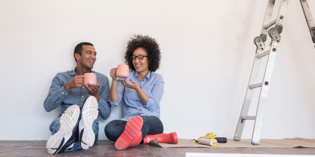 young couple enjoying working on new home